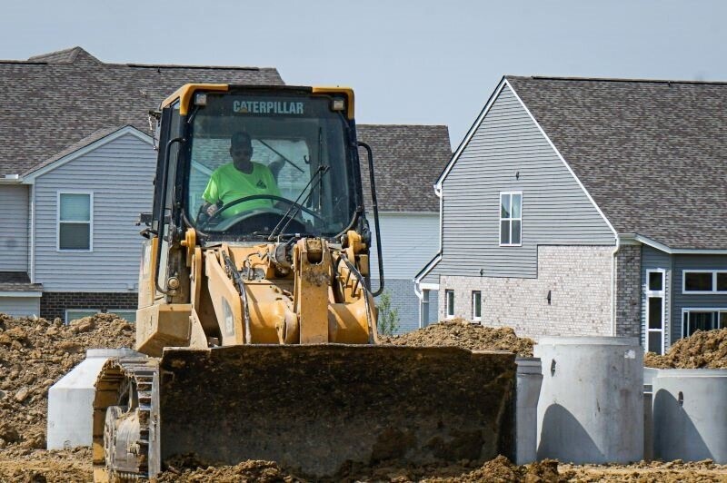 an earth moving vehicle pushes dirt